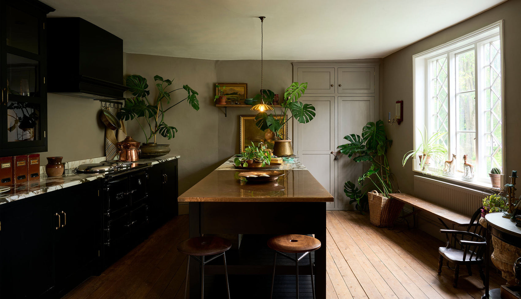 An exotic, glamorous kitchen with black painted Shaker cupboards
