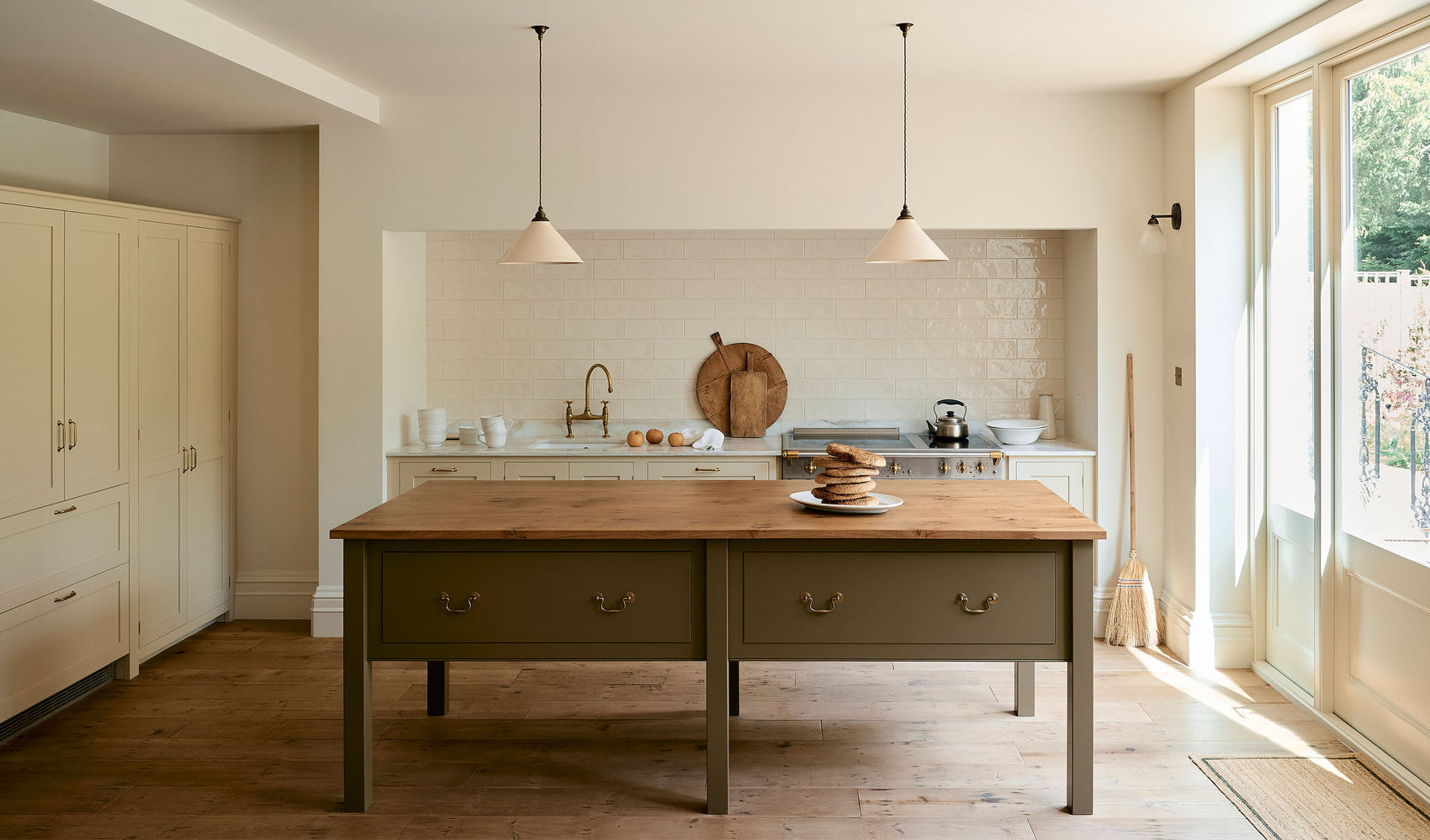A light, simple Shaker kitchen with a sink and a marble worktop